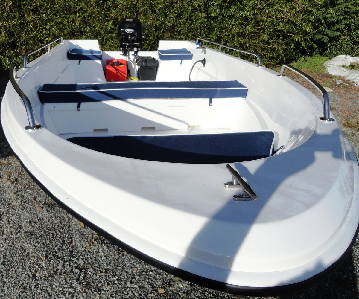 White motorboat with blue seating; parked outdoors.