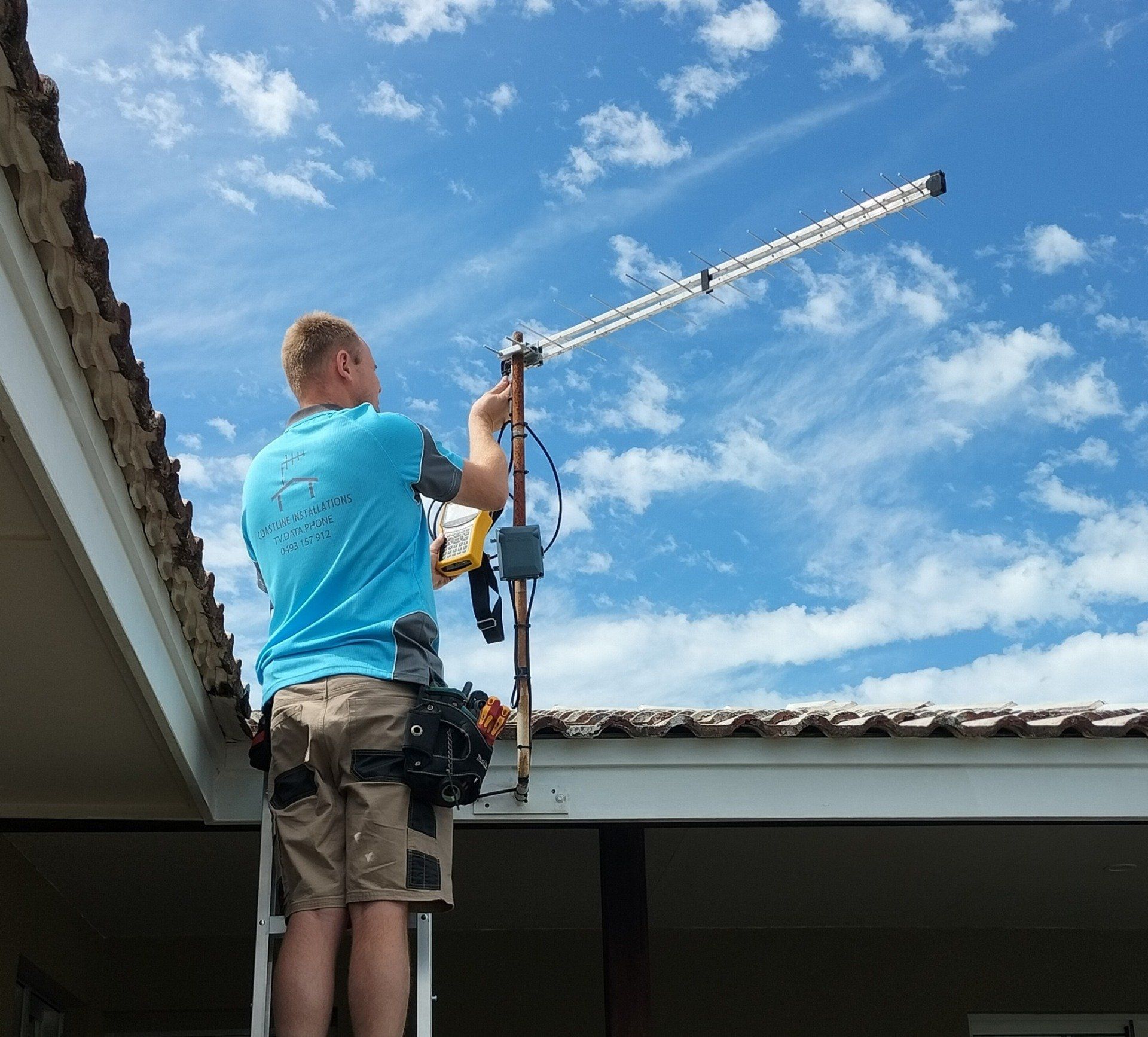 Worker Installing TV Antenna — Coastline Installations In Emu Park, QLD