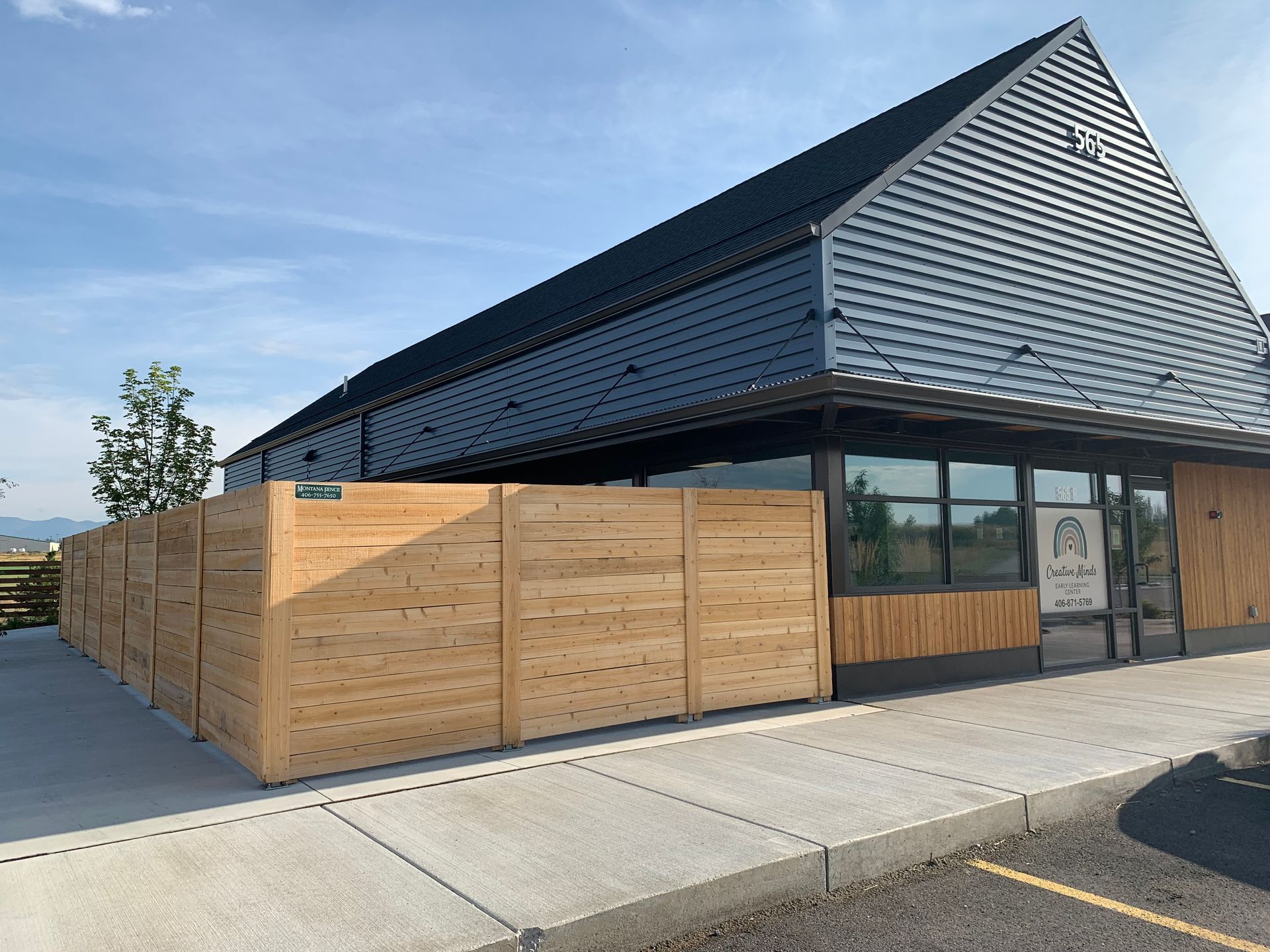 A large building with a wooden fence in front of it.