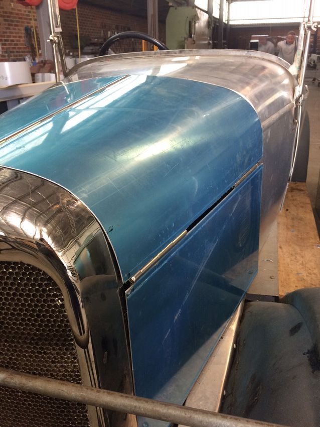 A Blue Car Is Sitting on A Wooden Floor in A Garage — R&M Sheetmetal Nowra Metal Roofing in South Nowra, NSW