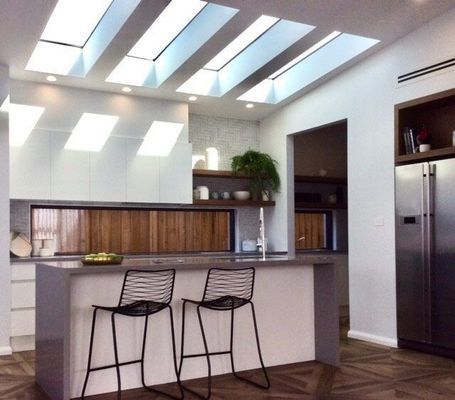 Modern Kitchen With Island, Skylights, White Cabinets — R&M Sheetmetal Nowra Metal Roofing in South Nowra, NSW