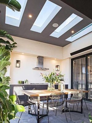 Outdoor Dining Area With a Table, Chairs, Skylights, and Plants — R&M Sheetmetal Nowra Metal Roofing in South Nowra, NSW
