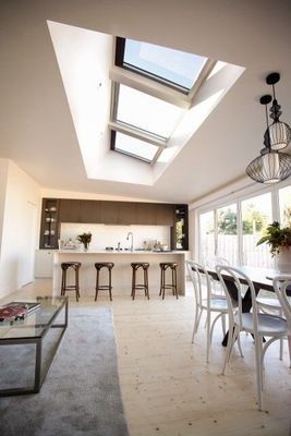Modern Dining Room With Skylights, Kitchen Island, and Dining Table With Chairs — R&M Sheetmetal Nowra Metal Roofing in South Nowra, NSW