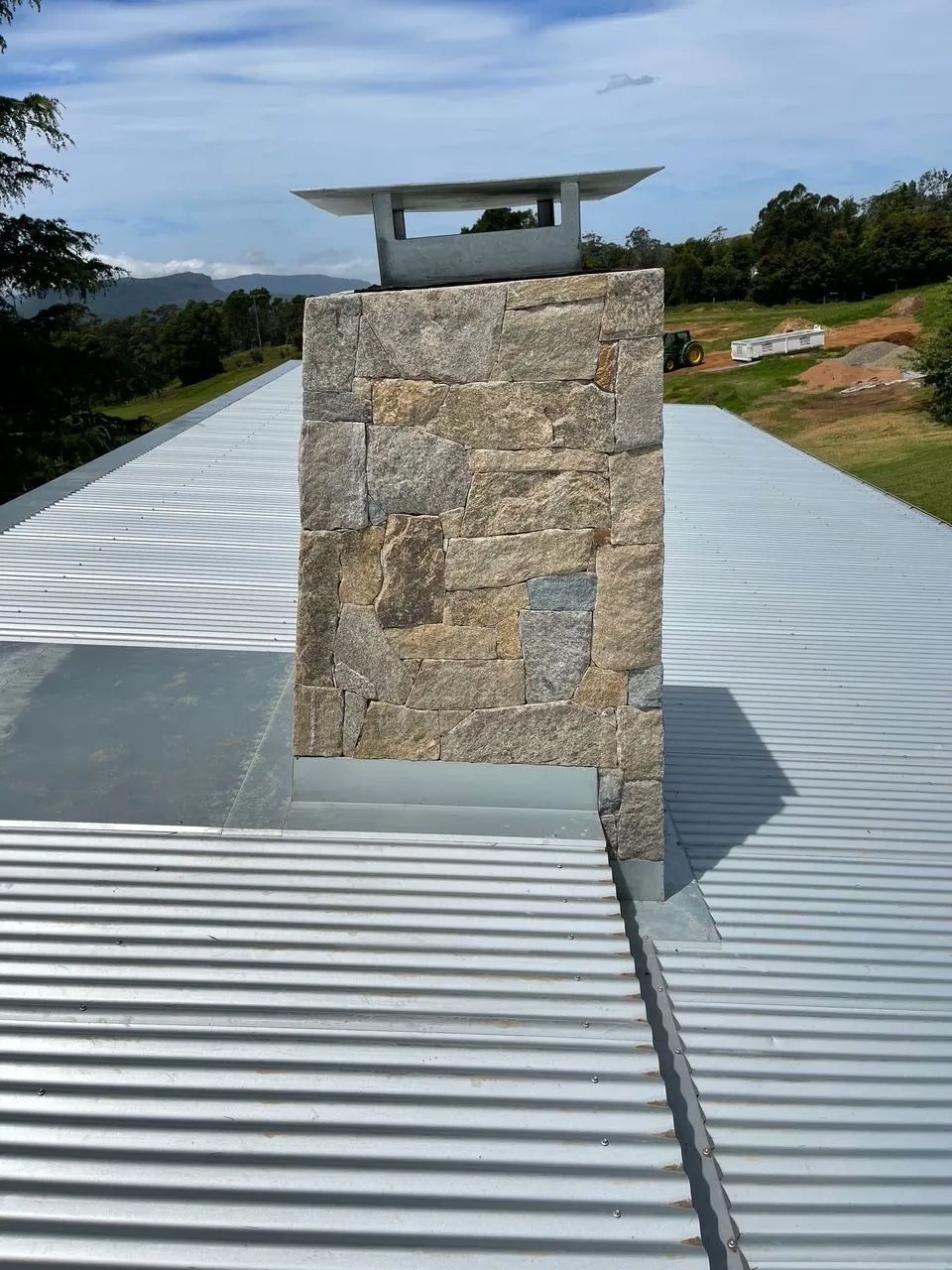 A Stone Chimney on Top of a Metal Roof — R&M Sheetmetal Nowra Metal Roofing in Culburra, NSW