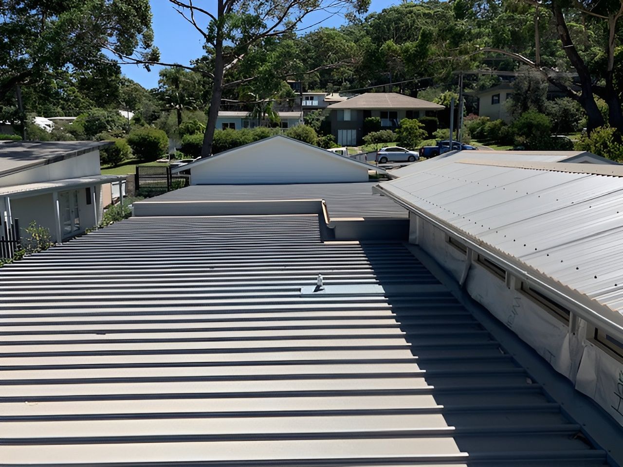 View from a metal roof overlooking other buildings and trees on a sunny day. — R&M Sheetmetal Nowra Metal Roofing in South Nowra, NSW