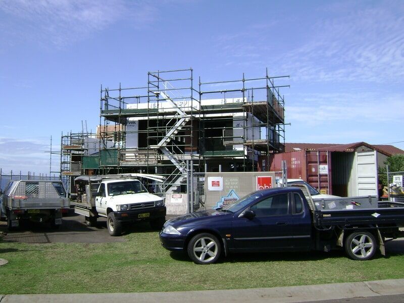 A Blue Truck Is Parked in Front of A Building Under Construction — R&M Sheetmetal Nowra Metal Roofing in South Nowra, NSW