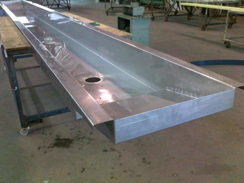 A Stainless Steel Sink Is Sitting on Top of A Wooden Table — R&M Sheetmetal Nowra Metal Roofing in South Nowra, NSW