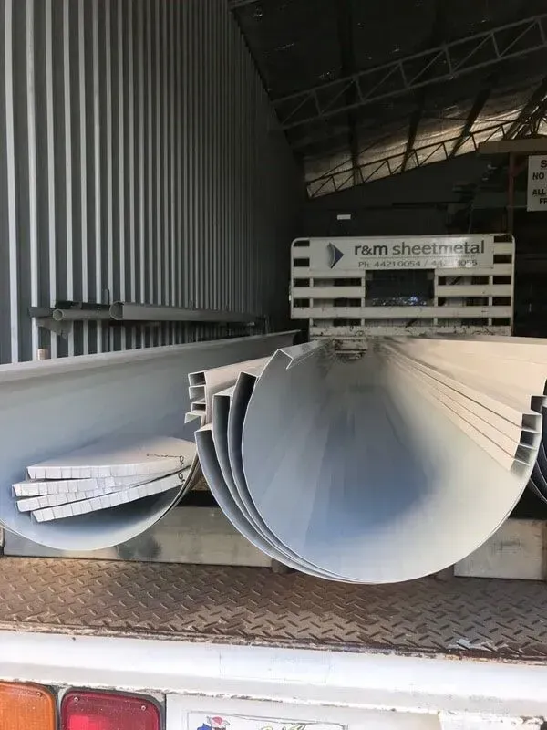 A Large White Pipe Is Sitting on The Back of A Truck — R&M Sheetmetal Nowra Metal Roofing in South Nowra, NSW
