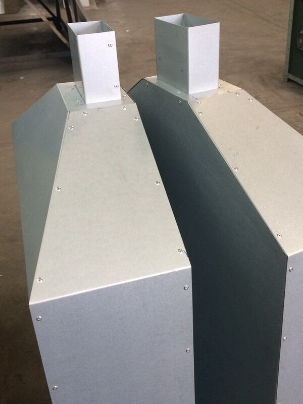 Two White Metal Boxes Are Sitting Next to Each Other on A Wooden Floor — R&M Sheetmetal Nowra Metal Roofing in South Nowra, NSW