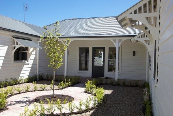 A White House with A Tree in Front of It — R&M Sheetmetal Nowra Metal Roofing in South Nowra, NSW