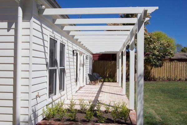 A White House with A Pergola on The Side of It — R&M Sheetmetal Nowra Metal Roofing in South Nowra, NSW