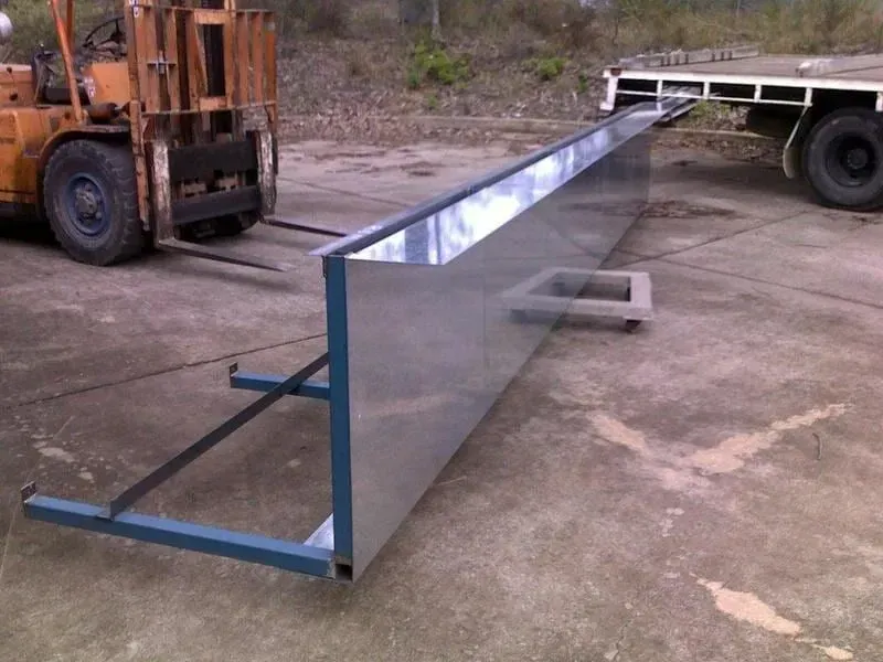 Large, rectangular, metal structure supported by a blue frame, near a forklift and a truck bed. — R&M Sheetmetal Nowra Metal Roofing in Nowra, NSW