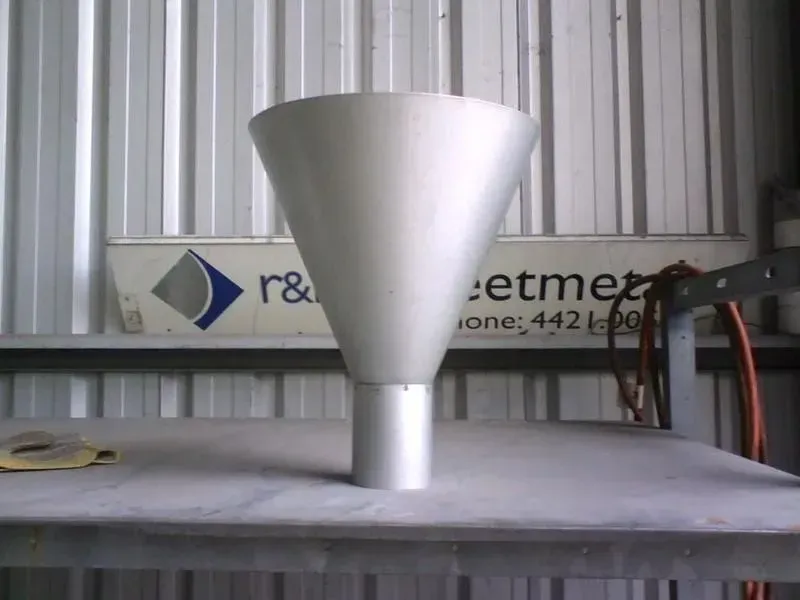 Silver metal funnel on a grey table, against a backdrop of a metal workshop. — R&M Sheetmetal Nowra Metal Roofing in South Nowra, NSW