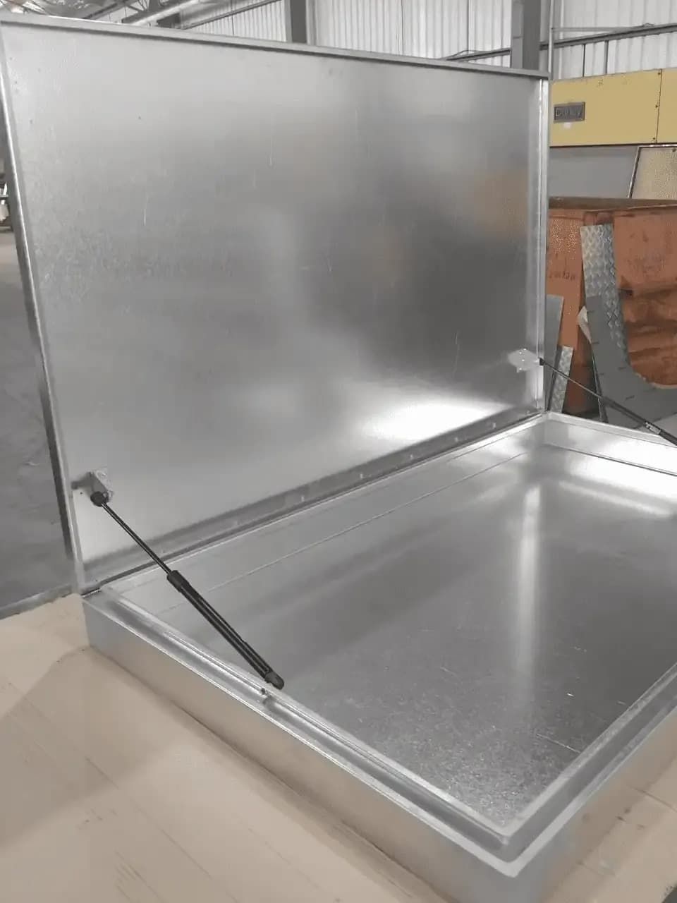 A Metal Box with The Lid Open Is Sitting on A Wooden Table — R&M Sheetmetal Nowra Metal Roofing in Sussex, NSW
