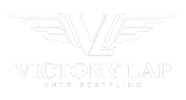 Logo for Victory Lap Auto Restyling: "V" shape with wings above text "VICTORY LAP AUTO RESTYLING".
