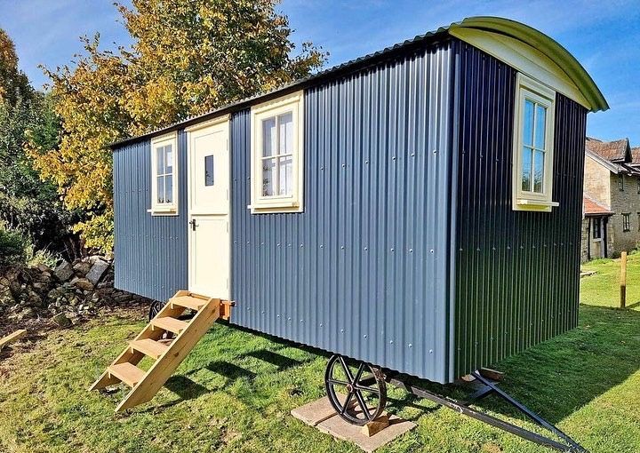 A cozy luxury shepherd hut in a green Cotswold meadow.