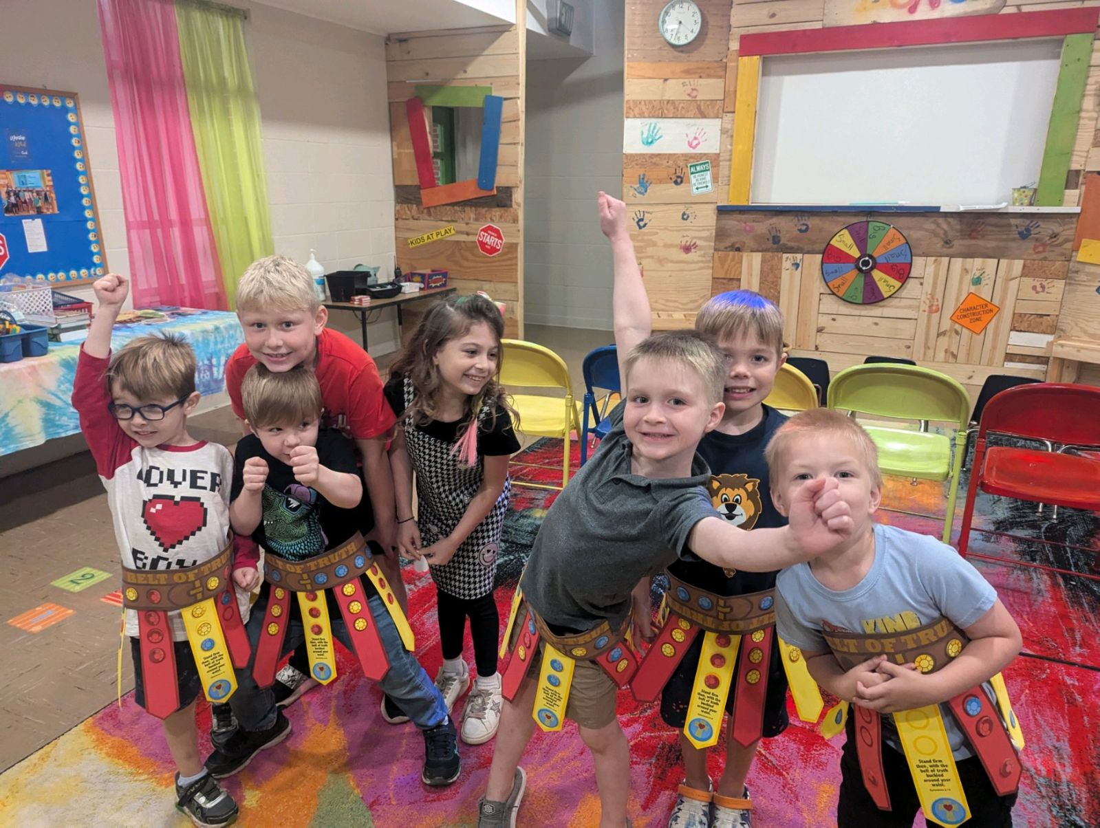 A group of children are posing for a picture in a room.