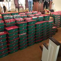 There are a lot of boxes stacked on top of each other in a room.