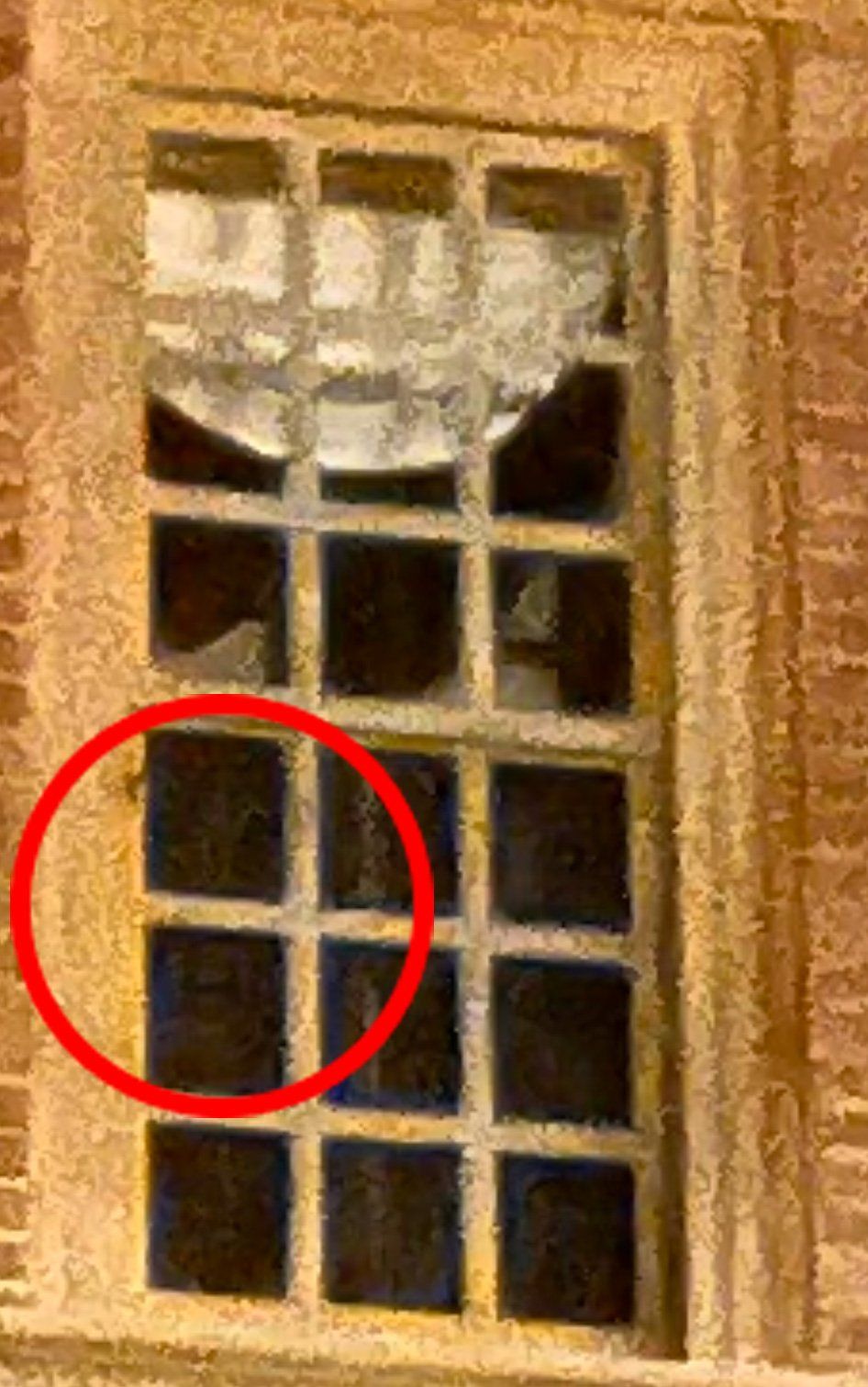 Broken window with multiple panes, circled in red.