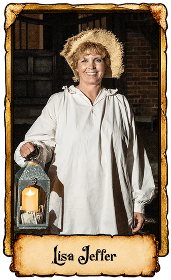 Woman in a white shirt and straw hat holding a lantern in a rustic interior.