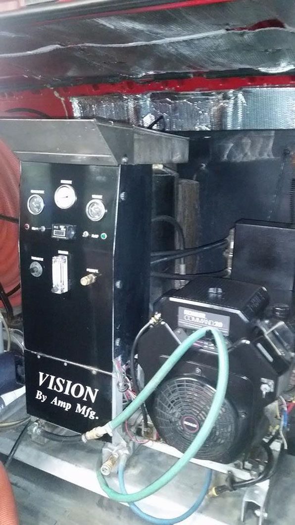 Black Vision machine with control panel and tubing inside a metallic enclosure