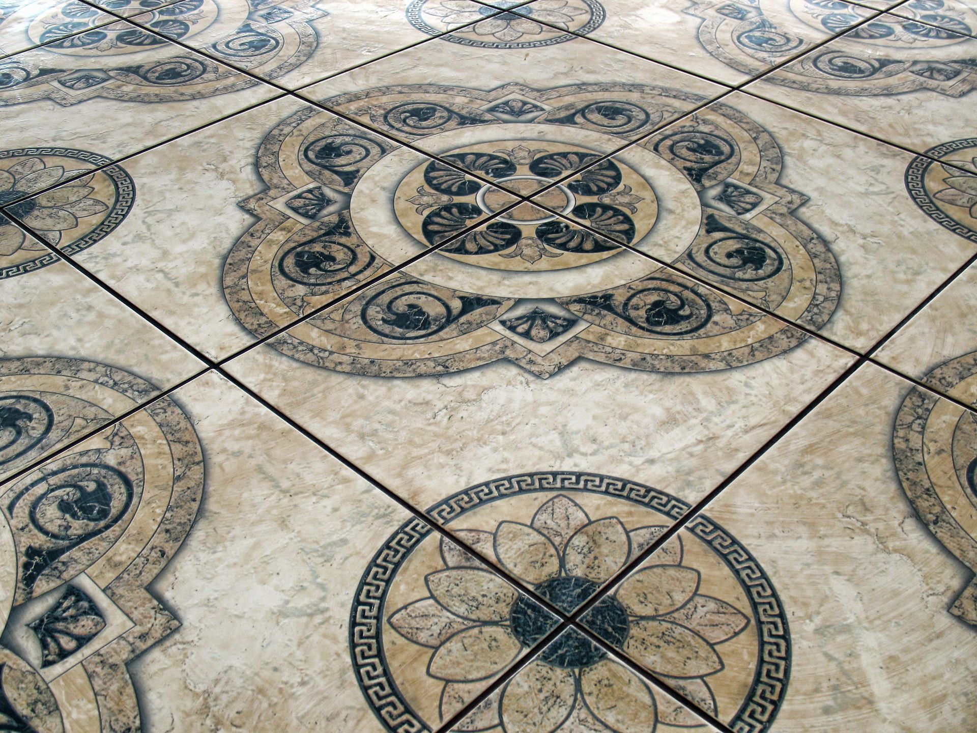 Decorative beige tiled floor with ornate circular blue-gray medallion patterns
