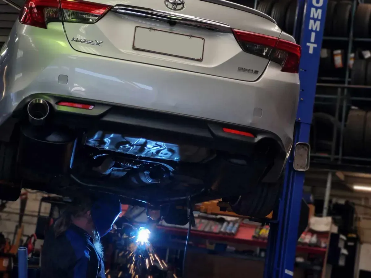 Car Being Worked on in a Shop — BJM Mechanical Mufflers & Tyres in Oxenford, QLD