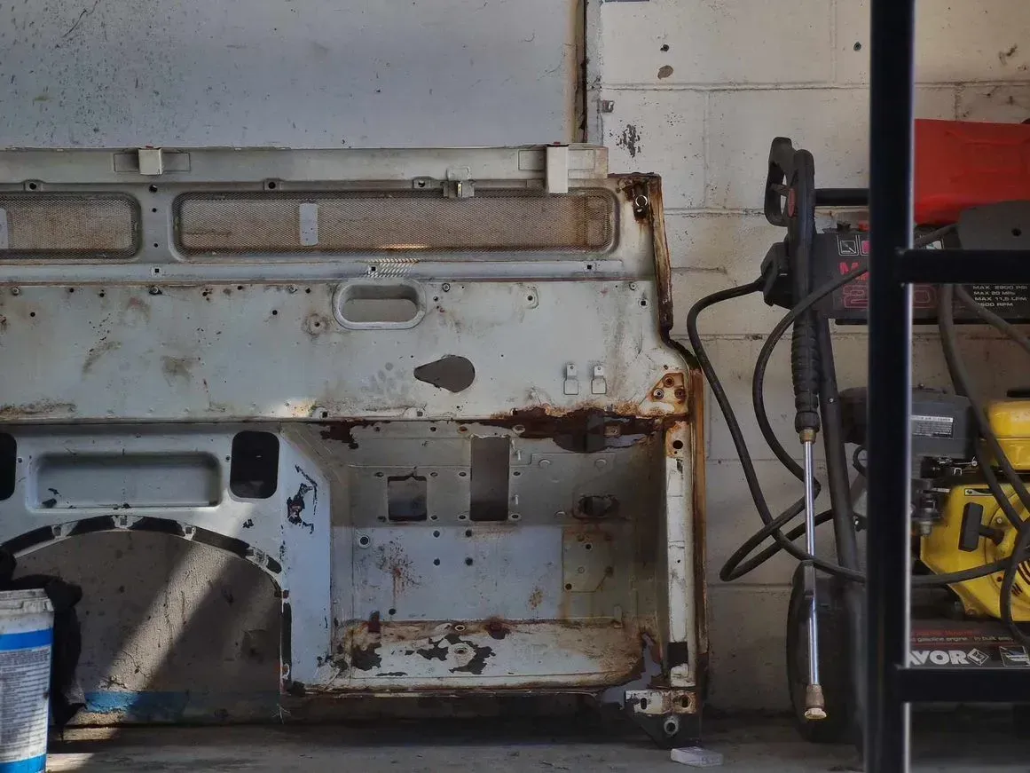 A Rusty White Metal Structure — BJM Mechanical Mufflers & Tyres in Oxenford, QLD