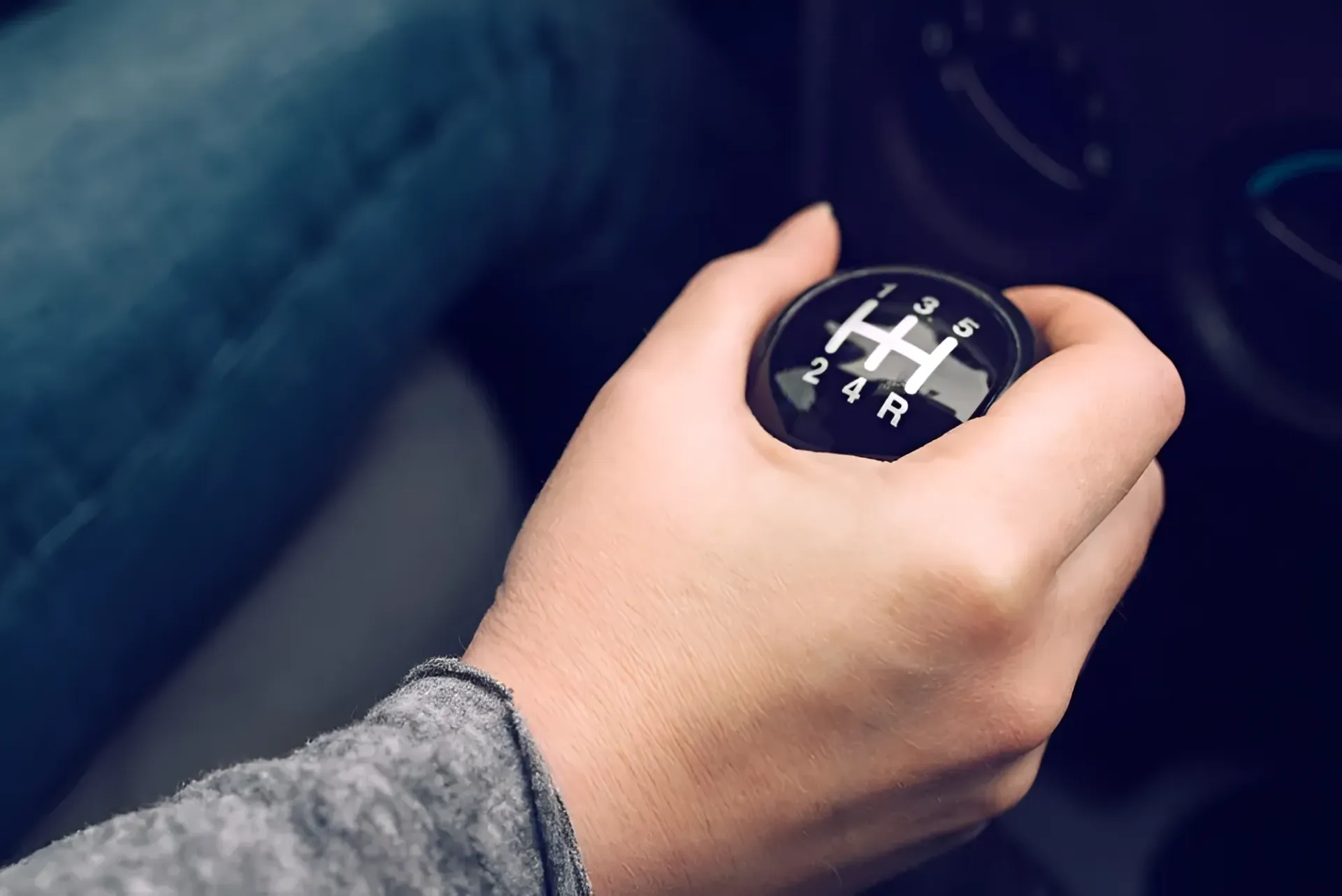 Hand on a Black Gear Shift in a Car — BJM Mechanical Mufflers & Tyres in Oxenford, QLD