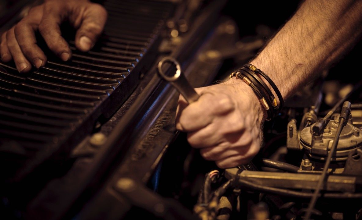 Auto Electrician Performing Vehicle Engine Diagnostics And Repairs