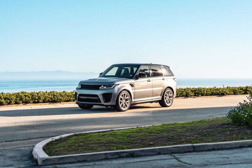 A Silver Range Rover Sport Suv Parked on A Road — BJM Mechanical Mufflers & Tyres in Oxenford, QLD