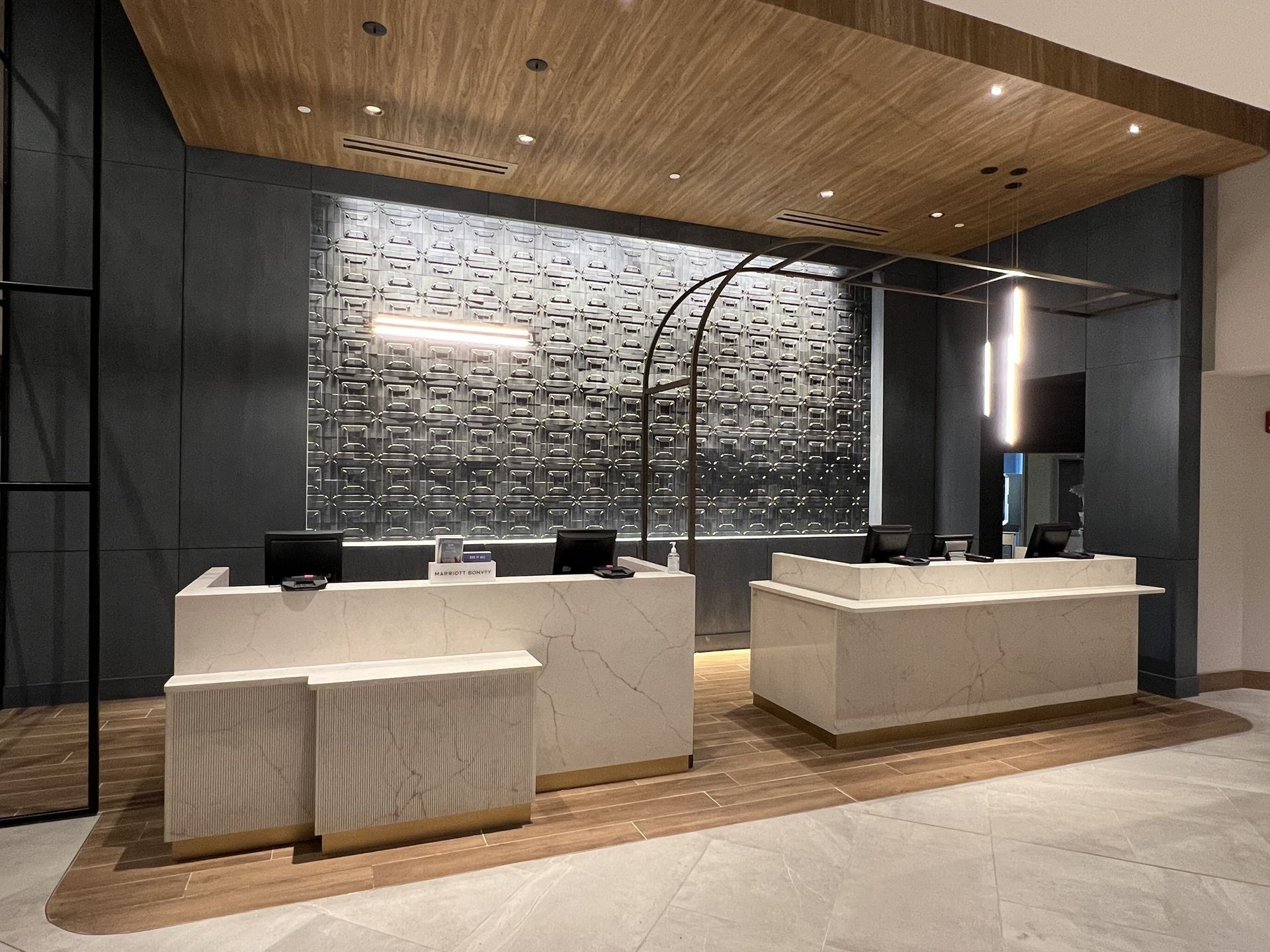 There are two reception desks in the lobby of a hotel.