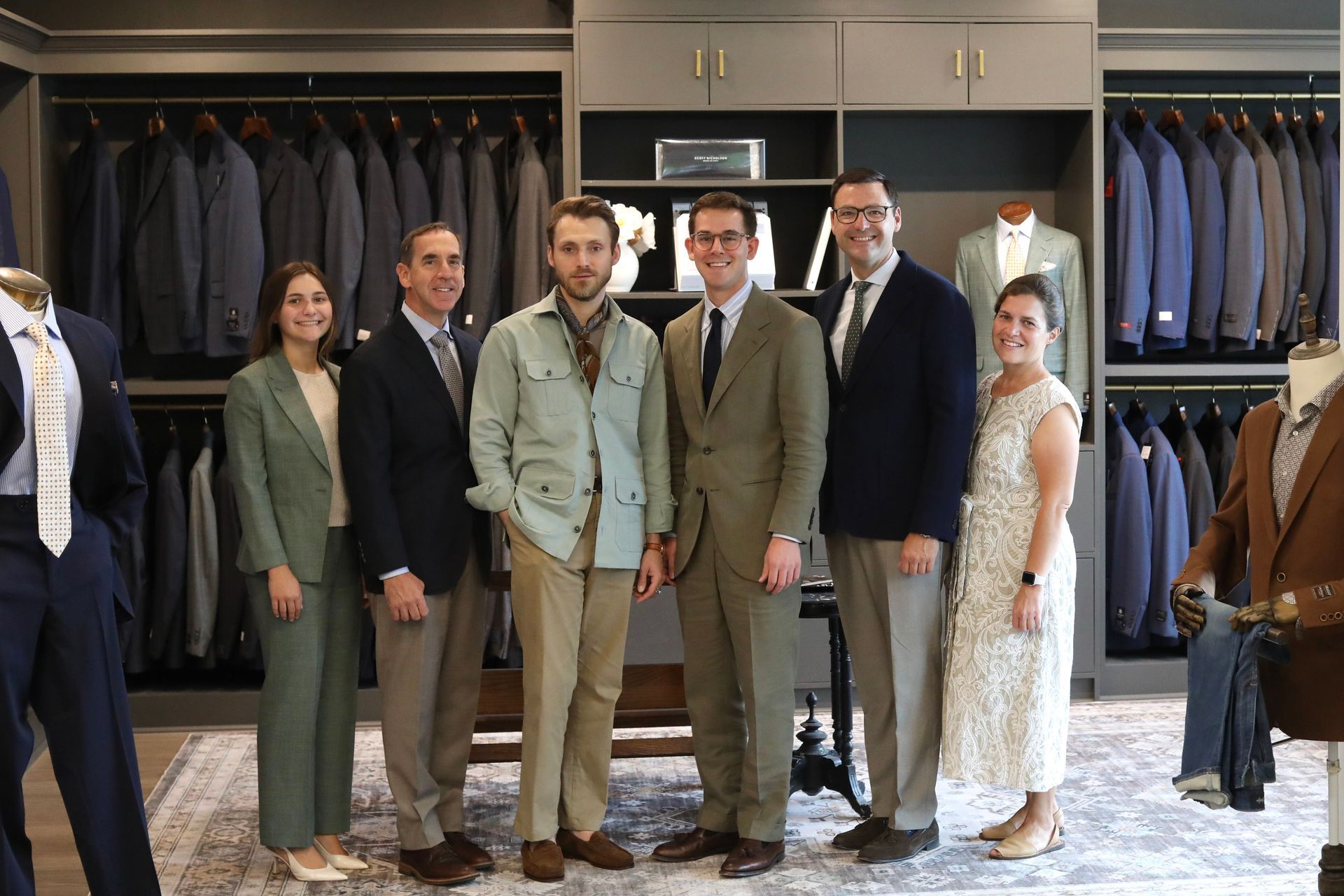 A group of people are posing for a picture in a room.