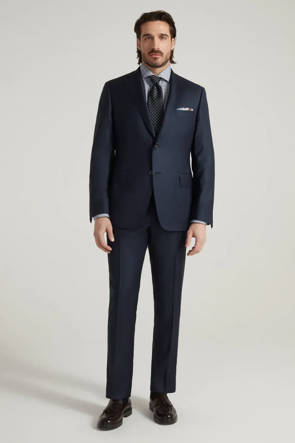A man is wearing a blue suit and tie.