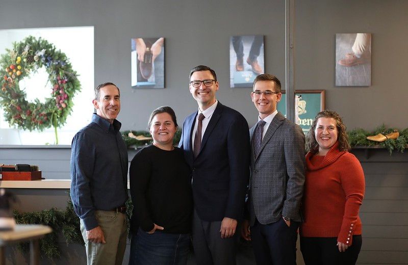A group of people are posing for a picture in a room.
