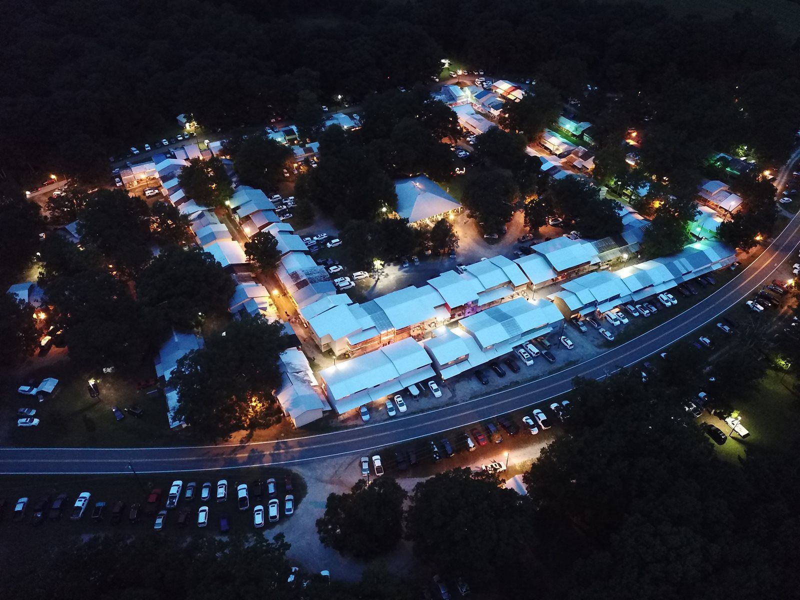 An aerial view of a campground at night with lots of lights