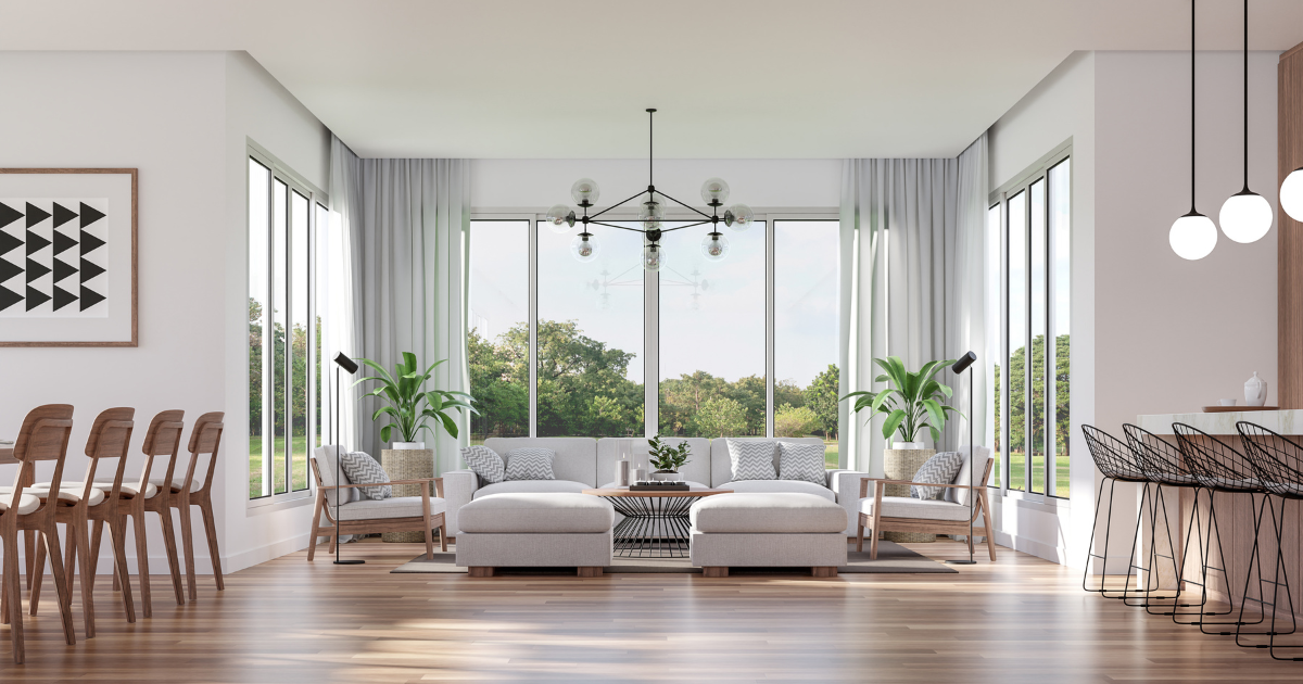 Elegant cream living room with striped sofas, TV, chandelier, and tall windows with drapes
