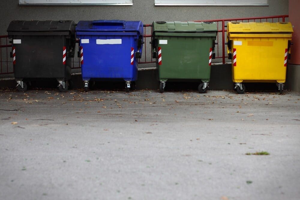 Four Trash Cans of Different Colors Are Lined Up in a Parking Lot — Bin in a Bath in Melbourne, VIC