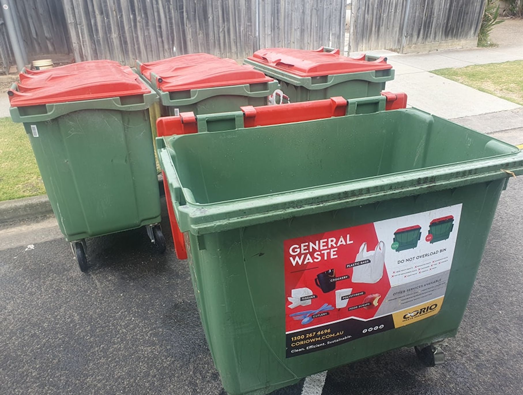 Three Green Garbage Cans With Red Lids Are Sitting on the Side of the Road — Bin in a Bath in Saint Albans Park, VIC