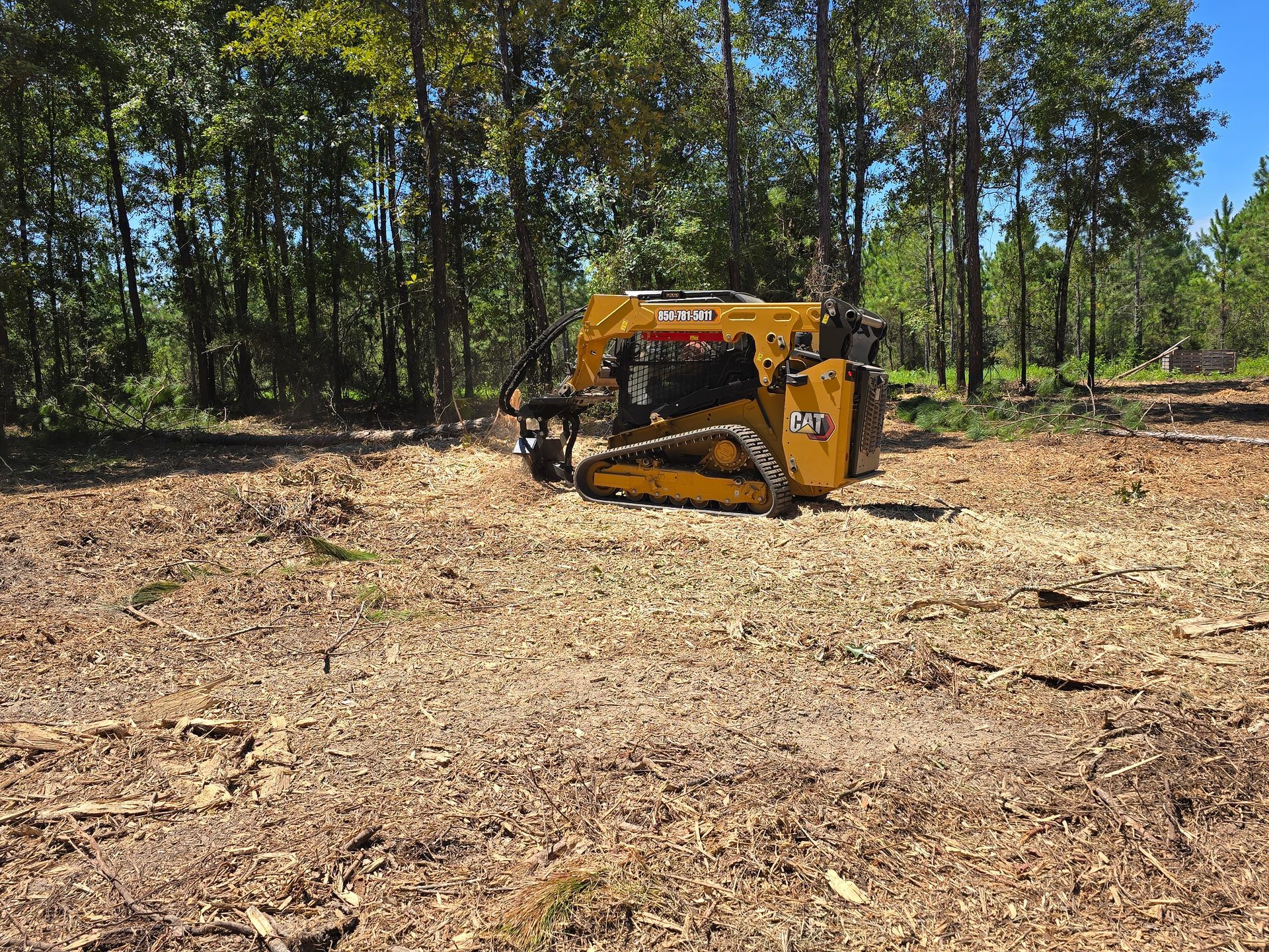 Bobcat excavator digging a trench in a yard, dumping soil onto the ground. Bobcat excavator digging a trench in a yard, dumping soil onto the ground.
