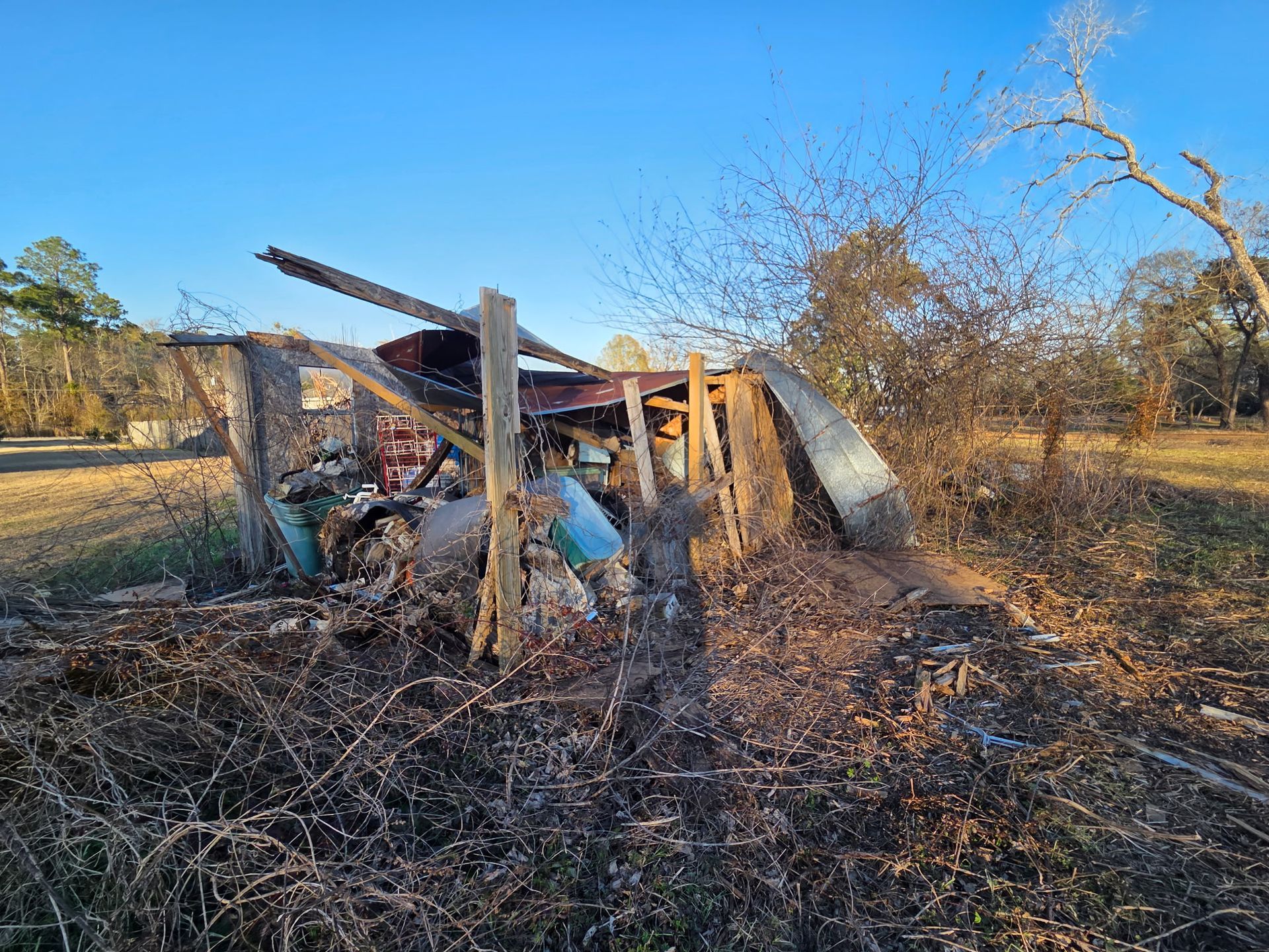 Demolition of a house, excavator loading debris into a truck; brick and wood wreckage. Demolition of a house, excavator loading debris into a truck; brick and wood wreckage.