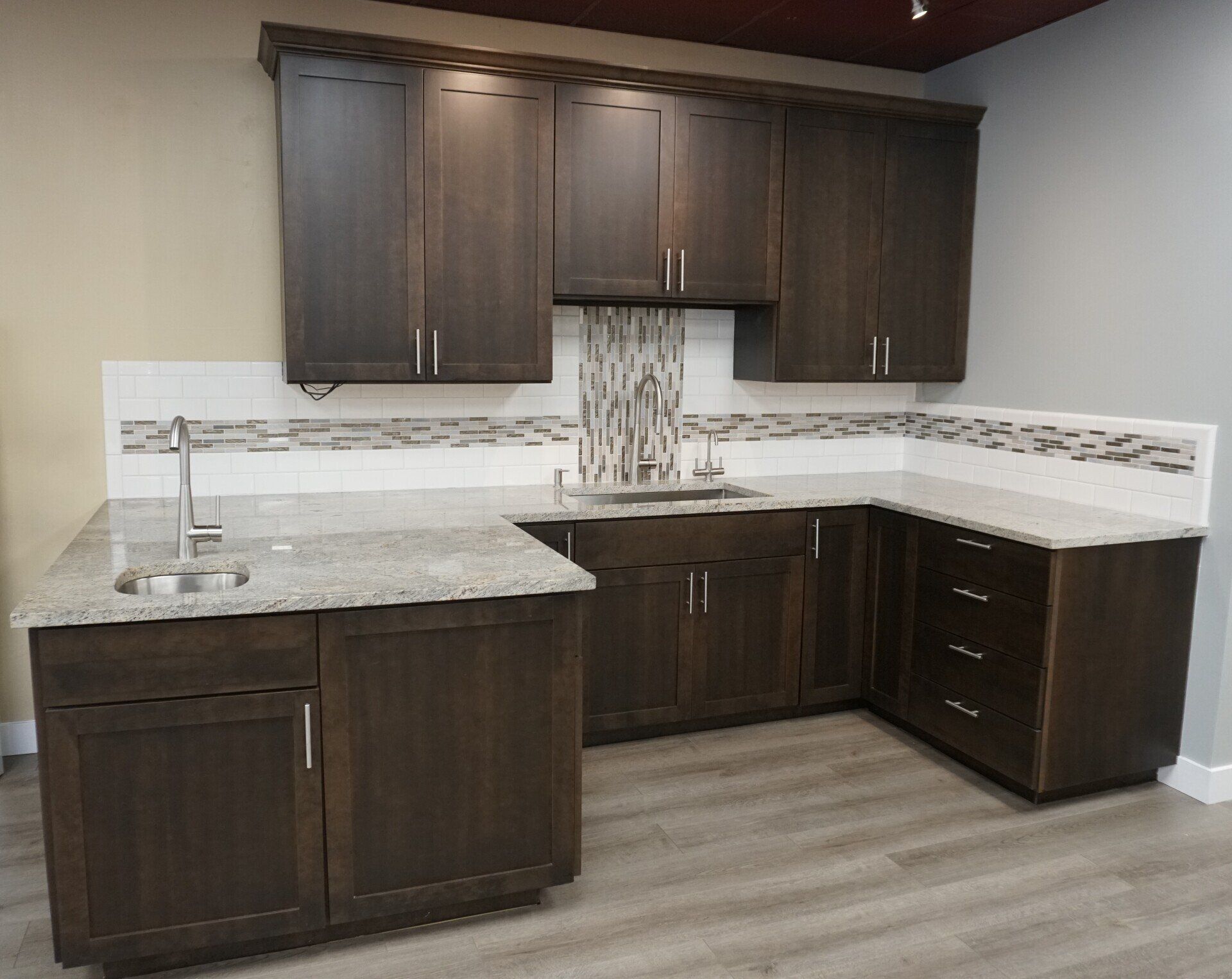 A kitchen with dark wood cabinets and granite counter tops