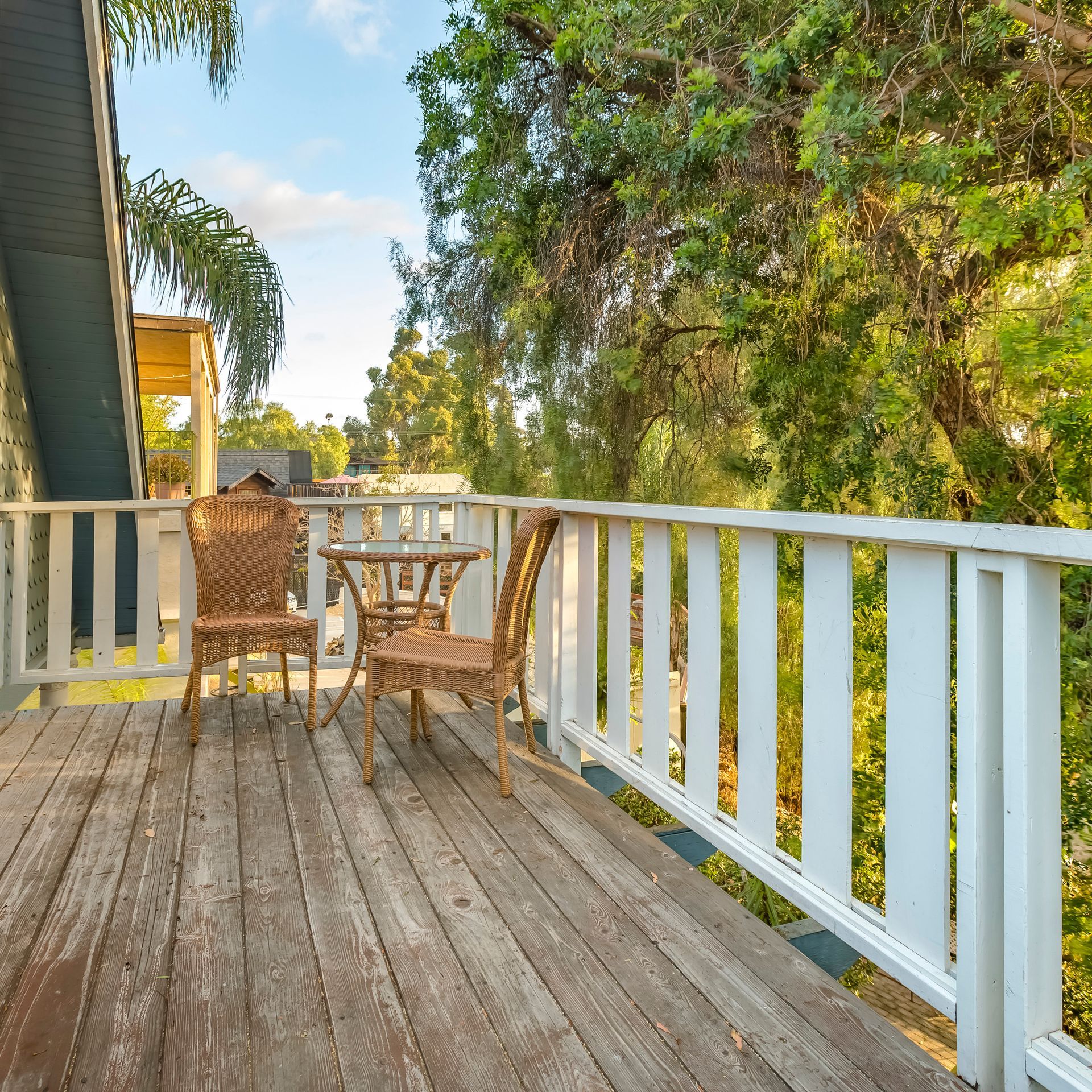 A wooden deck with a table and chairs on it