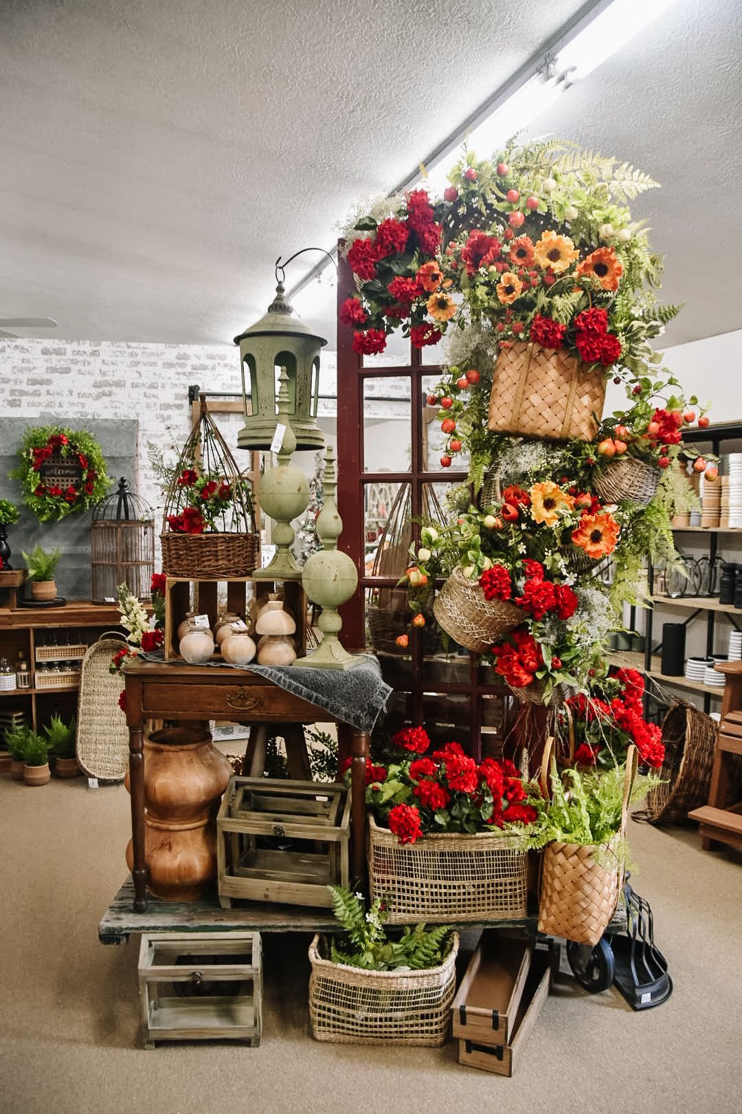 Display of floral arrangements and baskets, with a decorative garden theme.