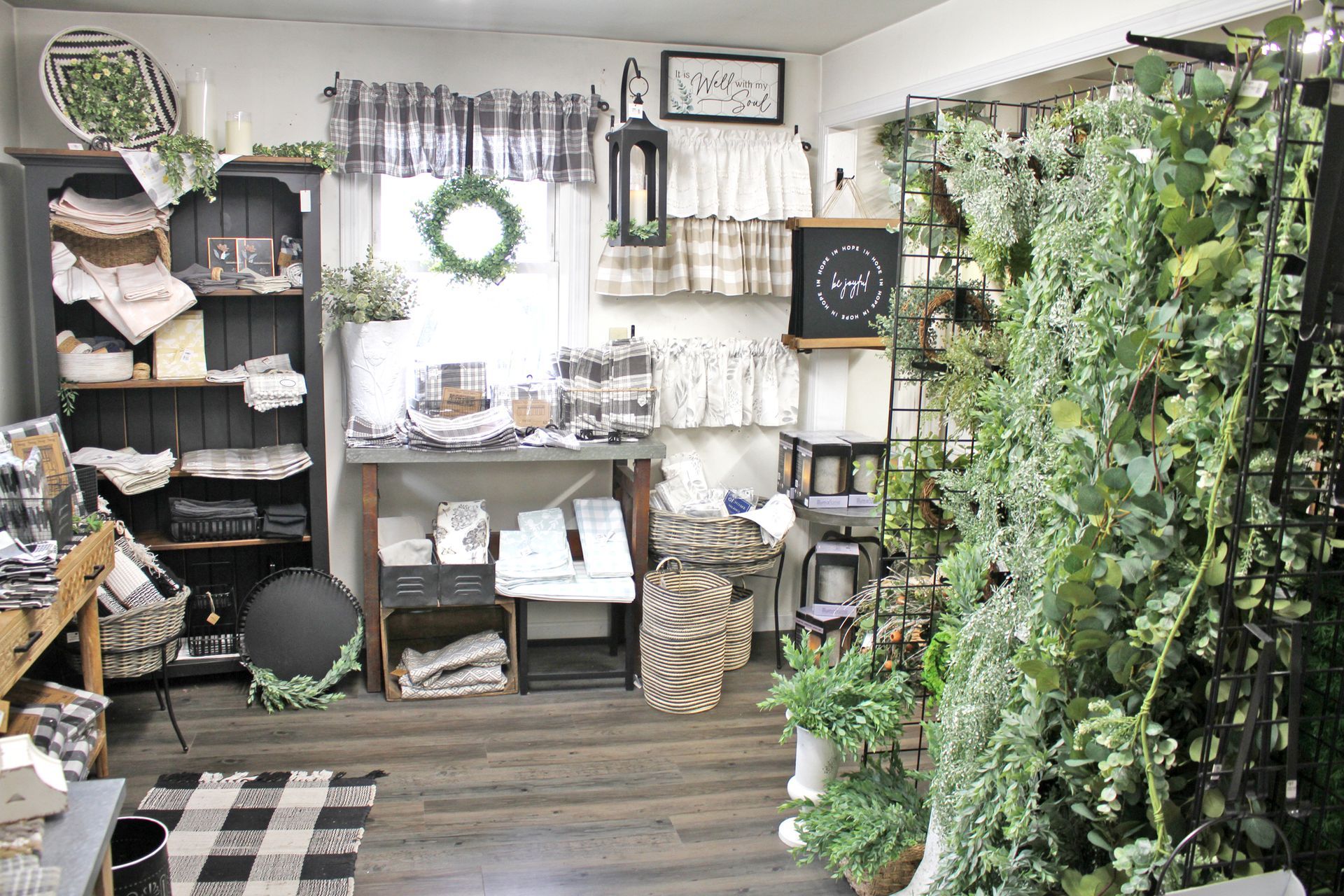Interior of a retail store with shelves, floral decor, and decorative items.