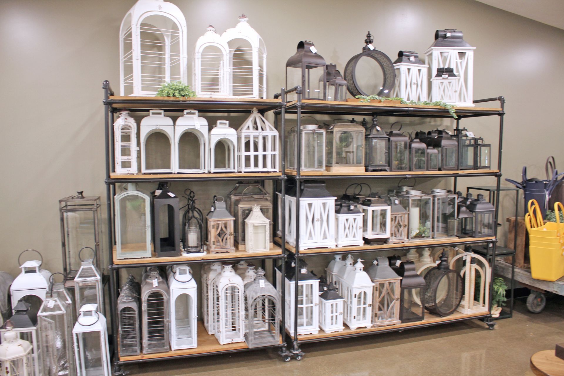 A display of various lanterns on wooden shelves in a store.