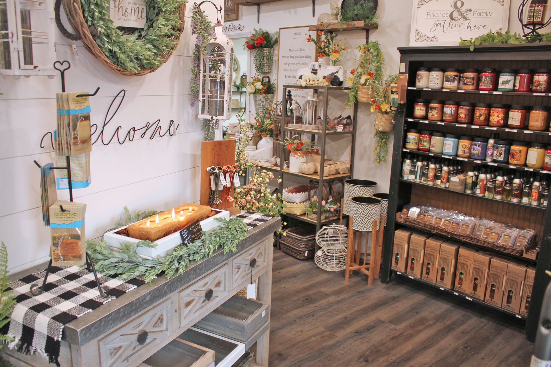 Interior of a gift shop with decorative items on display; including food products, wreaths, and holiday decor.