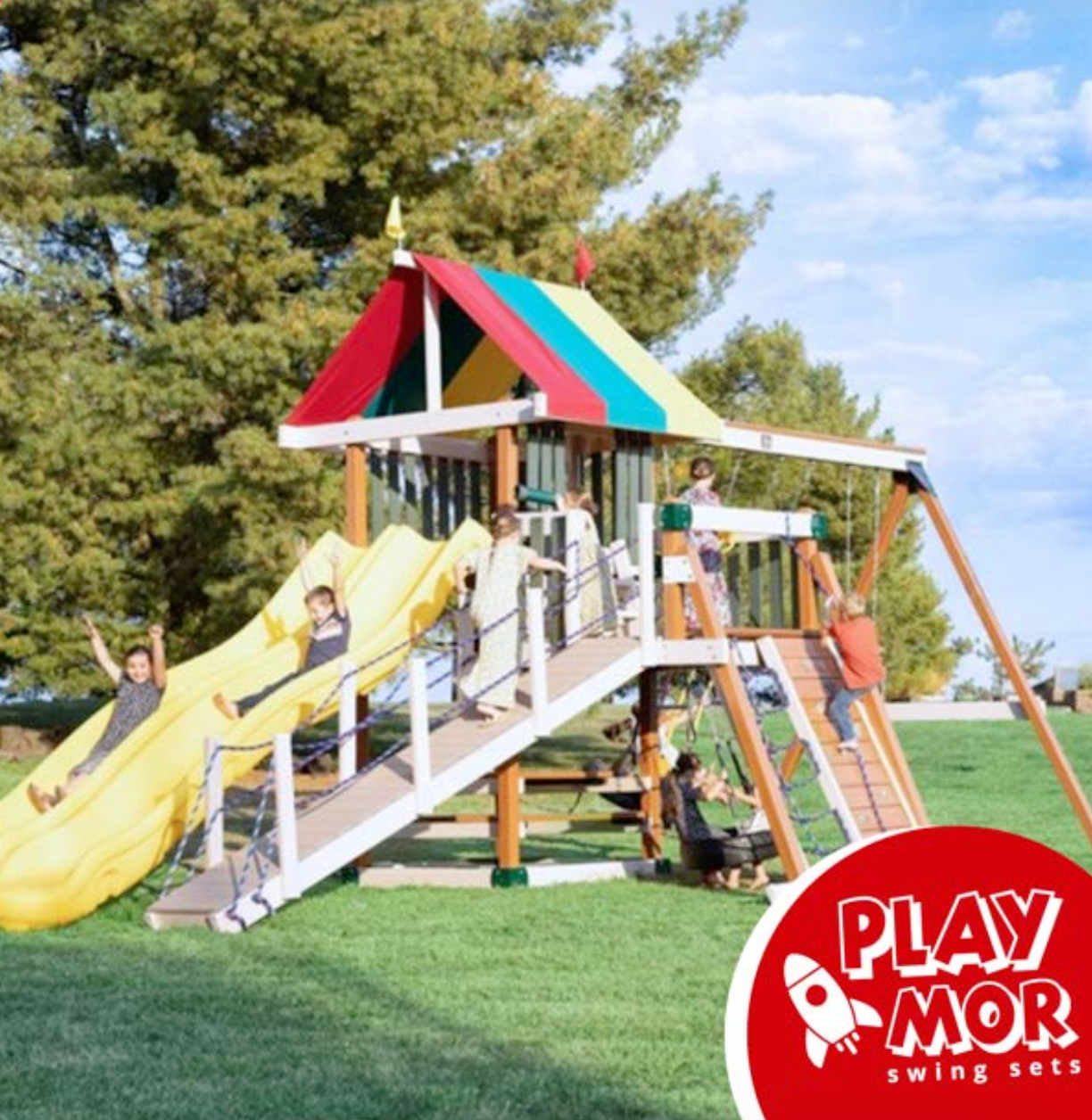 Play set with children playing, colorful roof, yellow slide, and rope climbing.