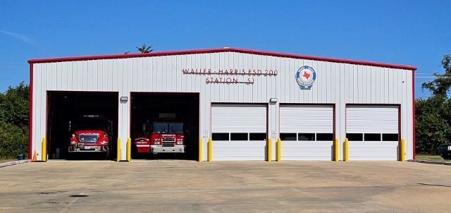 A picture of Waller-Harris ESD 200 Station 51 showing two fire trucks parked in the station.