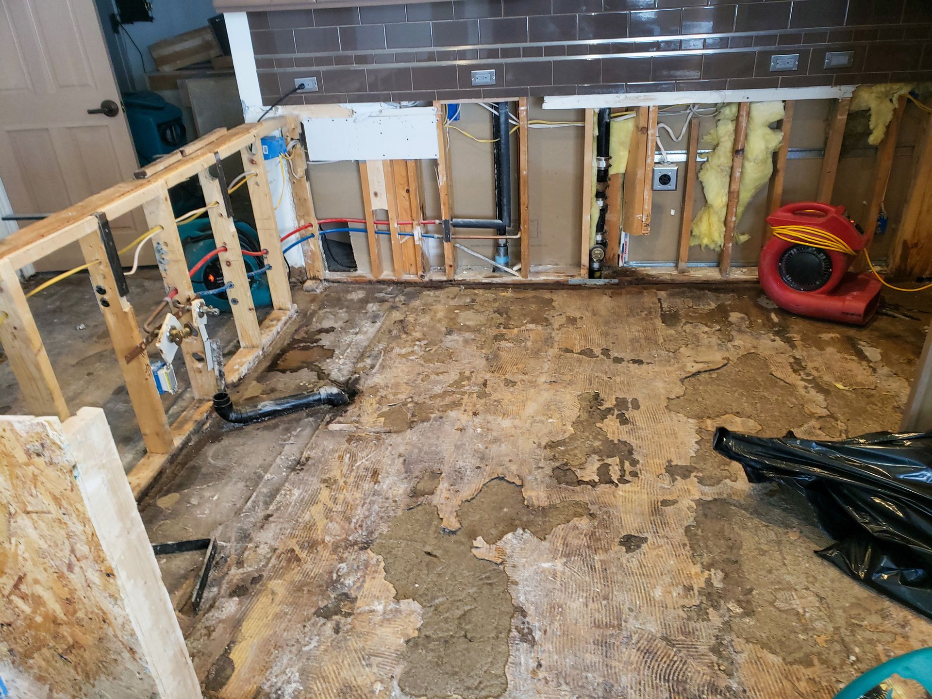 A room with a lot of wood and a fan on the floor.